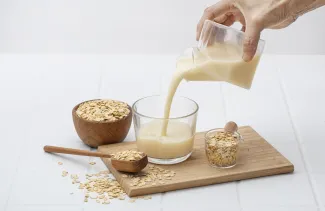 Oat milk being poured into glass