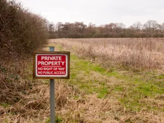 Trespassing sign in field