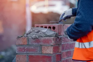 Construction worker laying bricks