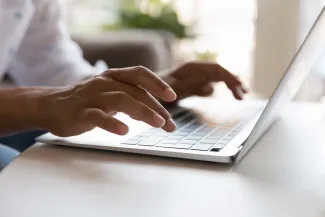 Hands typing on keyboard