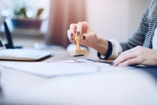 Woman legalising document with stamp