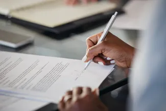 Woman hand signing document