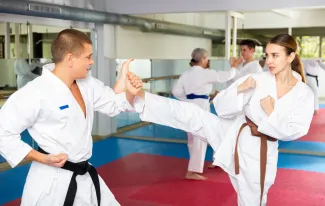 Woman in karate training wearing white gi