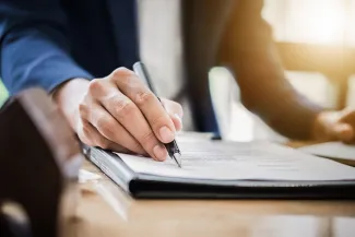 Man signing a will