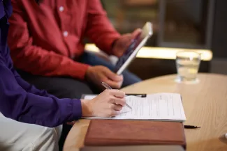 Two claimants looking at documents