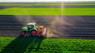 Tractor planting seeds on farm