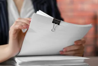 Woman holding pension paperwork