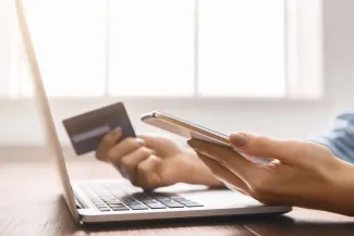 Woman booking hotel with phone and credit card