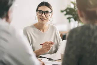 Woman discussing wills and estates with couple