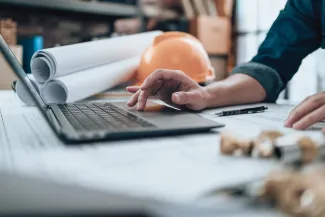 Construction industry worker at laptop