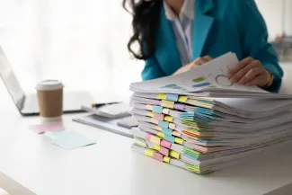 Woman flipping through stack of paperwork