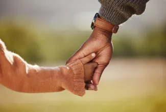 Father holding daughter's hand