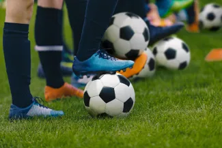 Football players with boot on ball