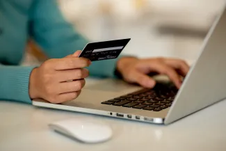 Person at laptop with credit card