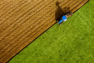Aerial shot of a tractor in a field