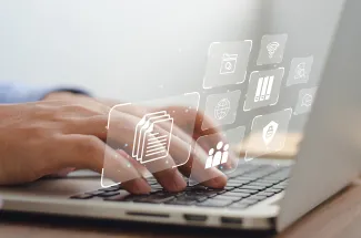 Person using a laptop with security graphics overlay