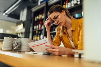 Stressed woman looking at paperwork