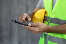 Construction worker using mobile