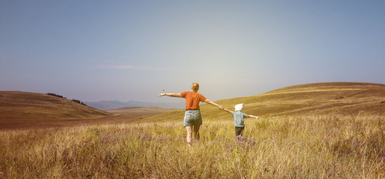 Landscape with walking family and country road in field