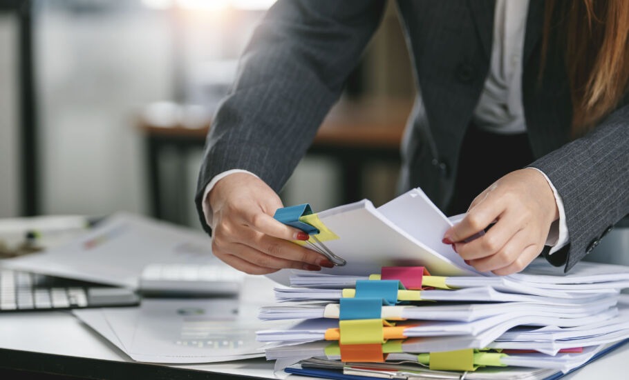 Woman going through stack of paperwork