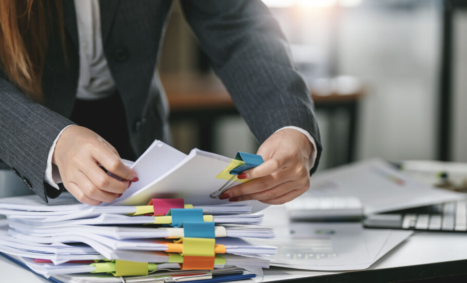 Woman going through stack of paperwork