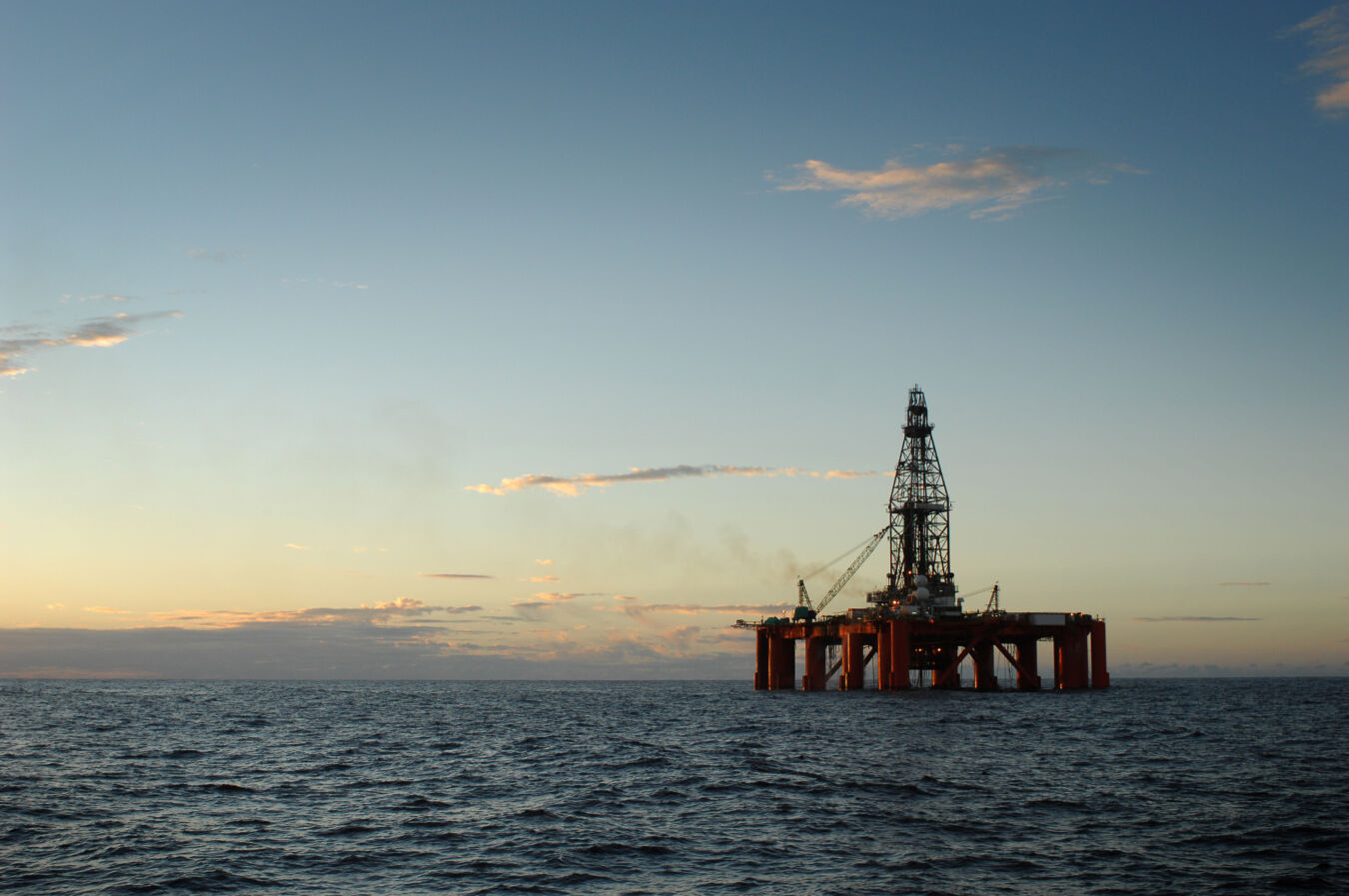 Oil rig platform at sunset