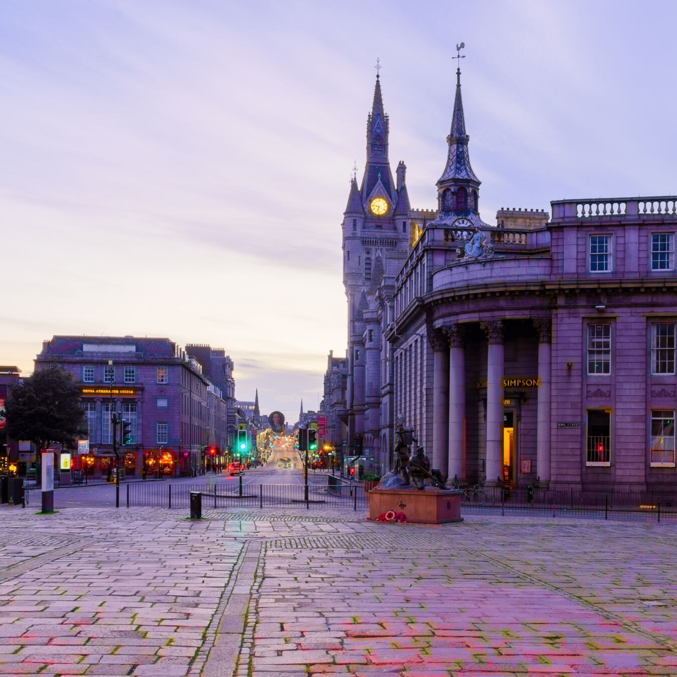 Aberdeen, UK - October 06, 2022: Sunset view of Castle Street in central Aberdeen, with locals and visitors. Scotland, UK