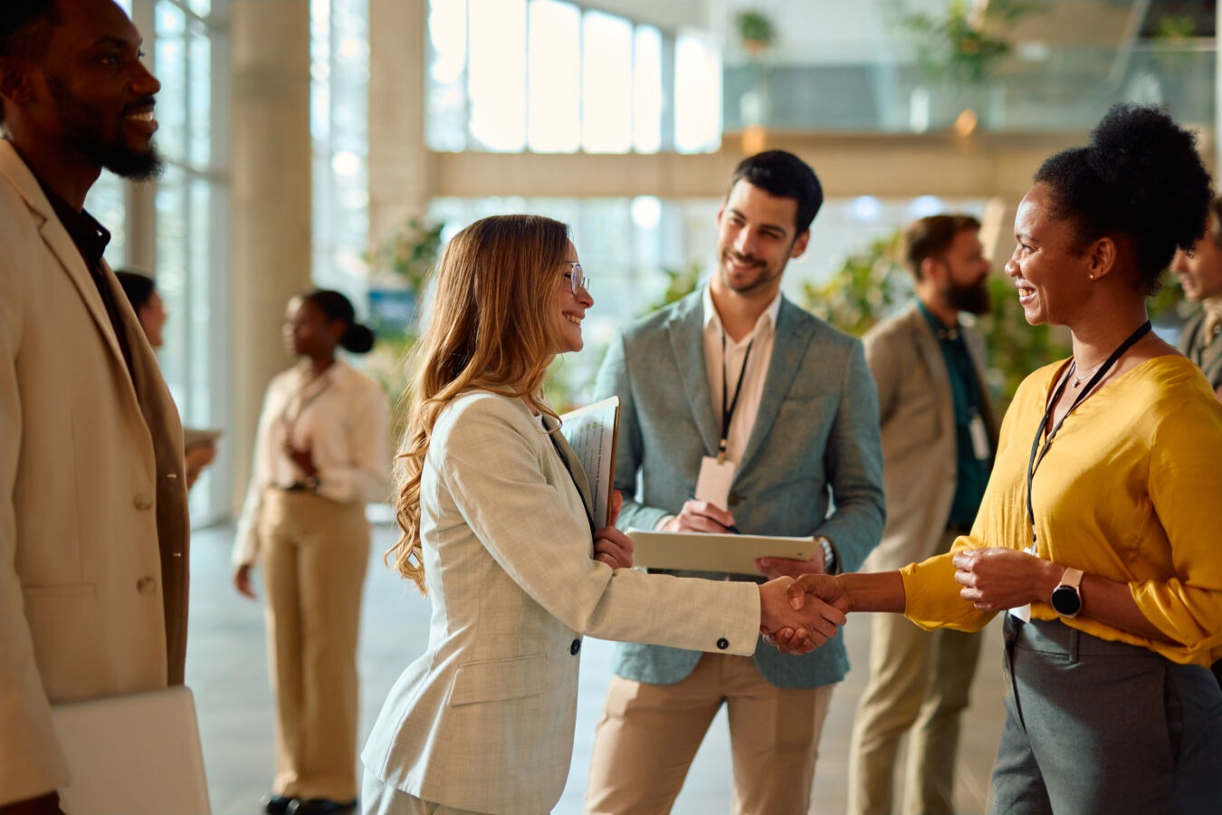 Women shaking hands at business event