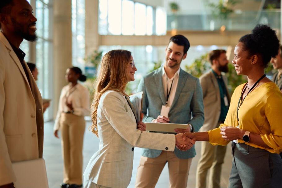 Women shaking hands at business event