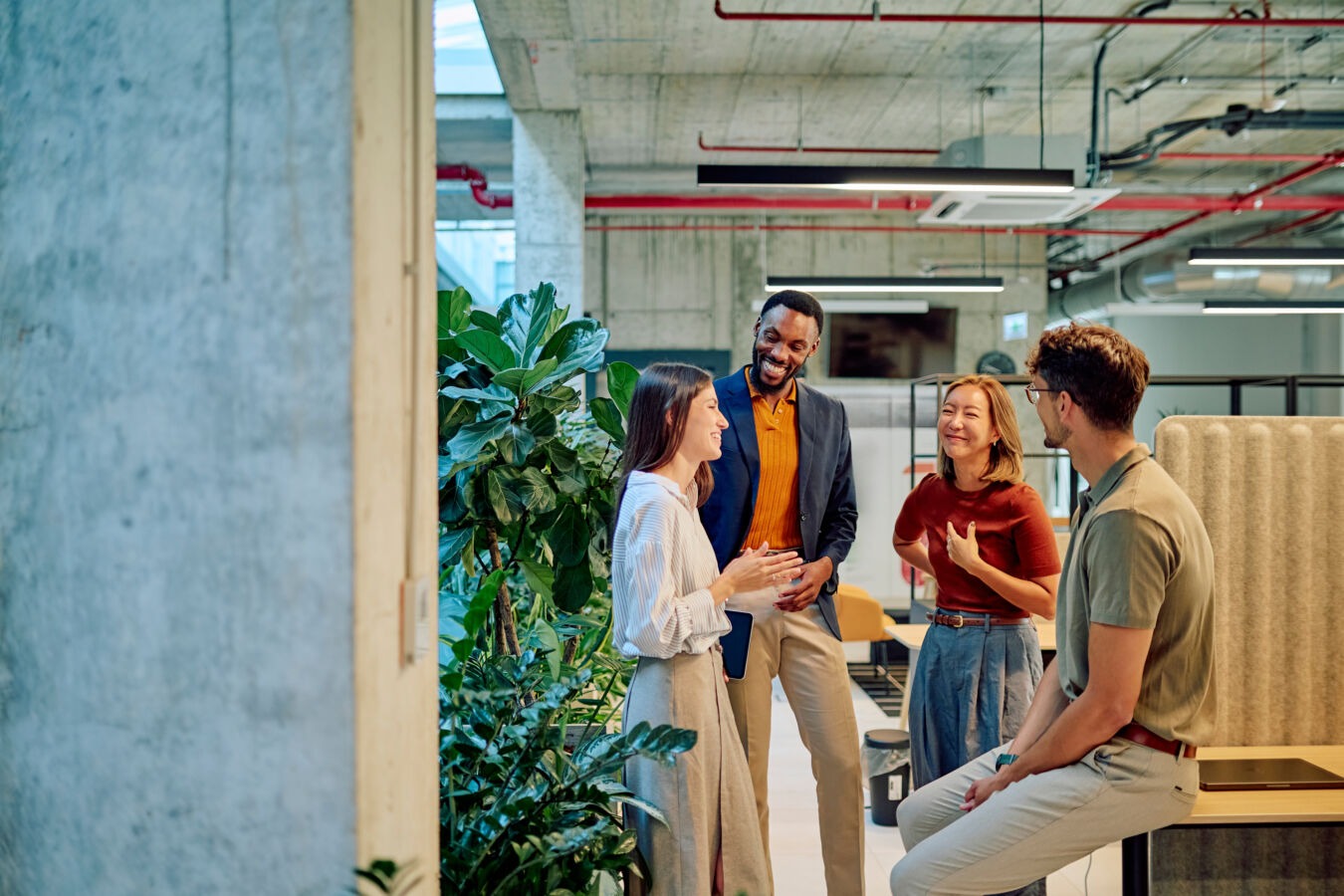 Diverse group chatting in office