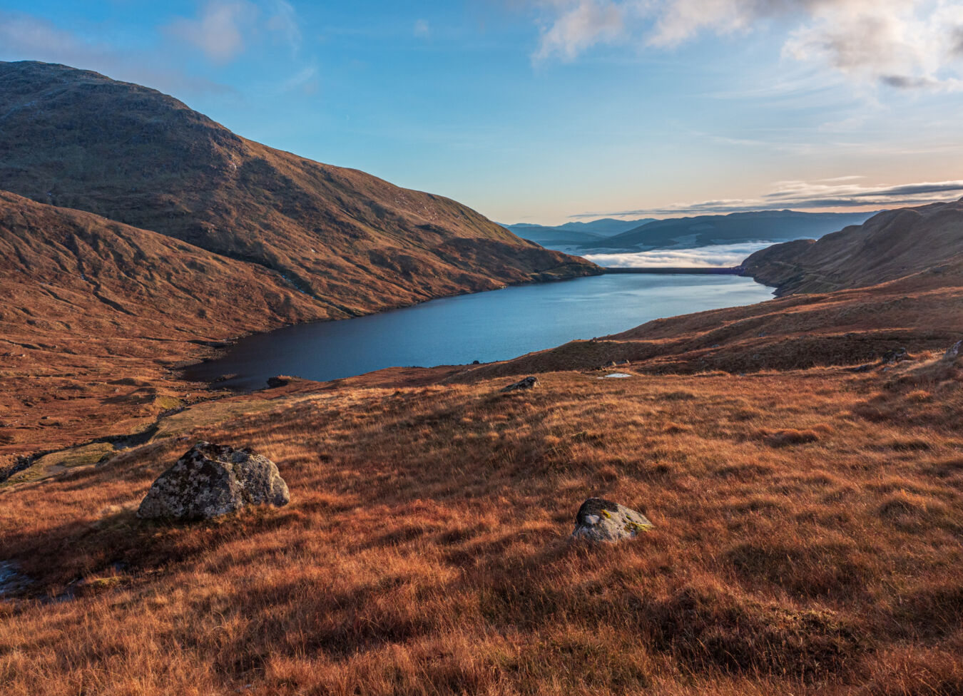 Loch in Scotland with mountains surrounding it
