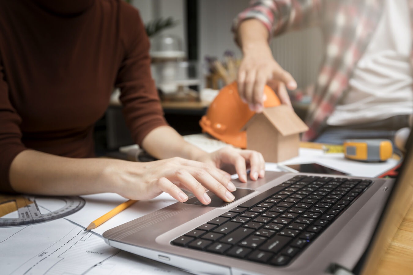 Construction worker looking at a laptop