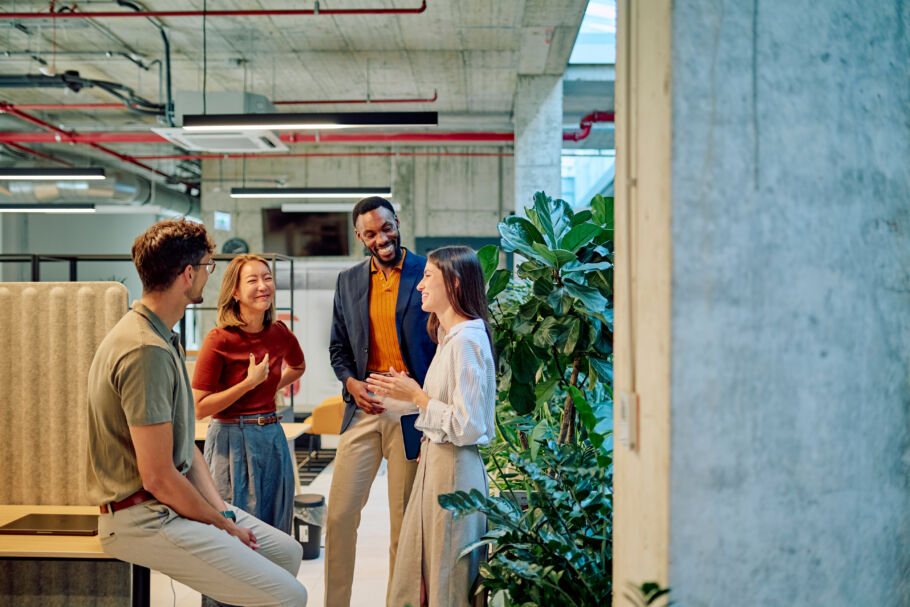 Diverse group of employees chatting in office
