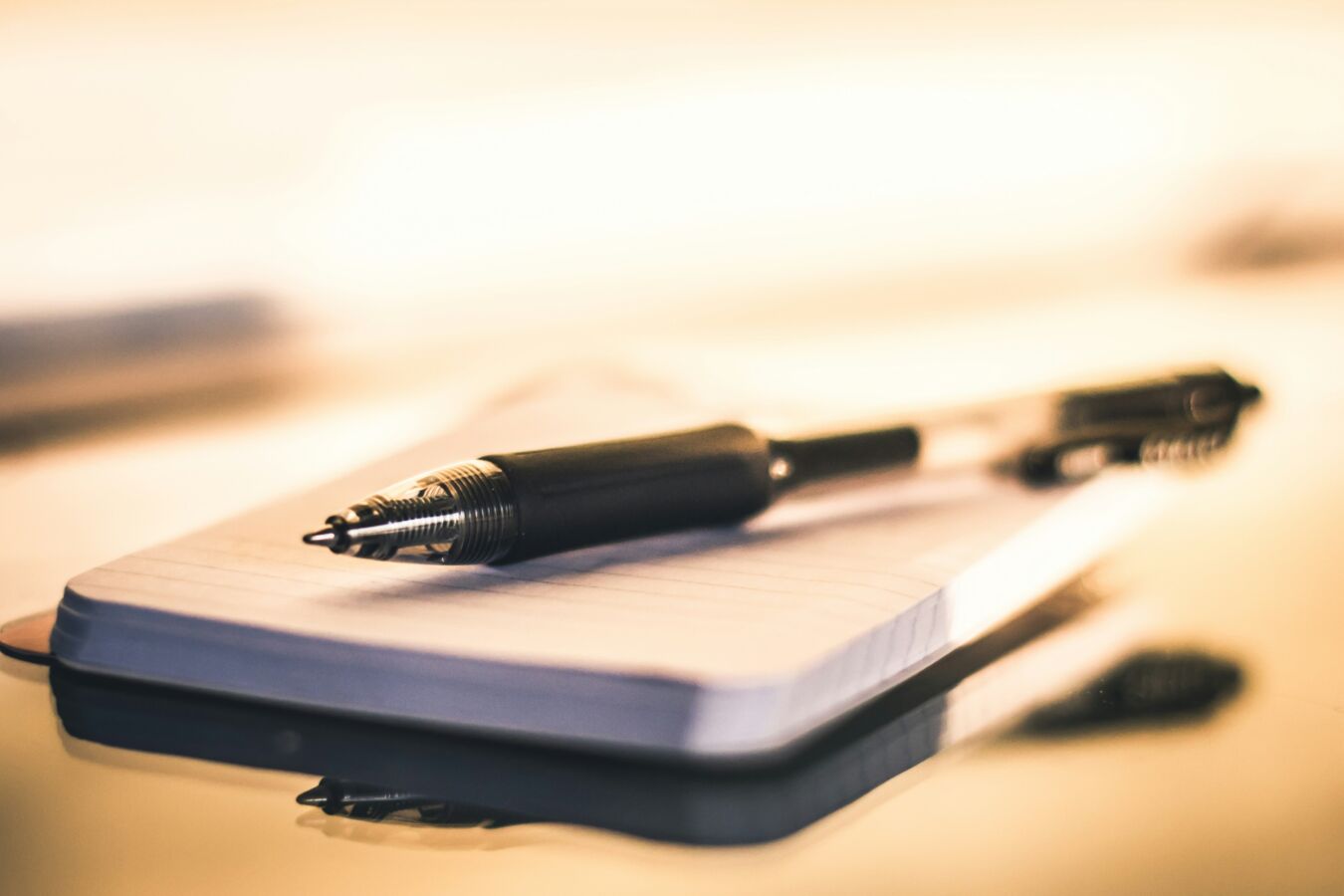 pen and paper on a desk