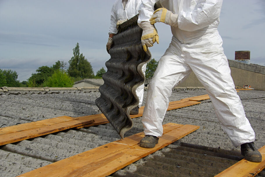 Workers removing asbestos from a roof