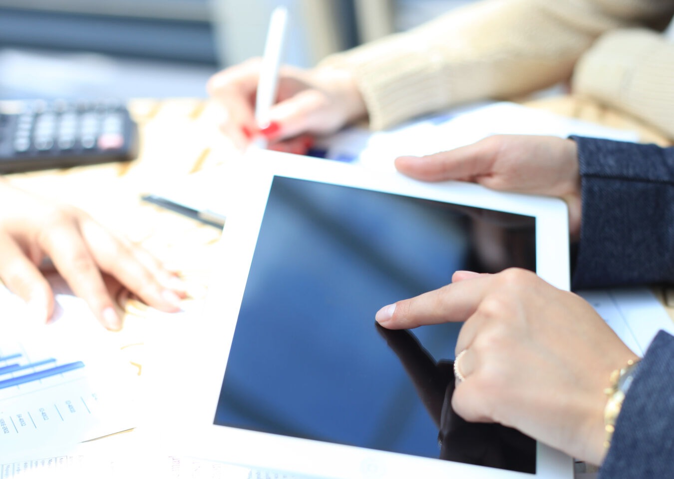 Two people working together with an iPad