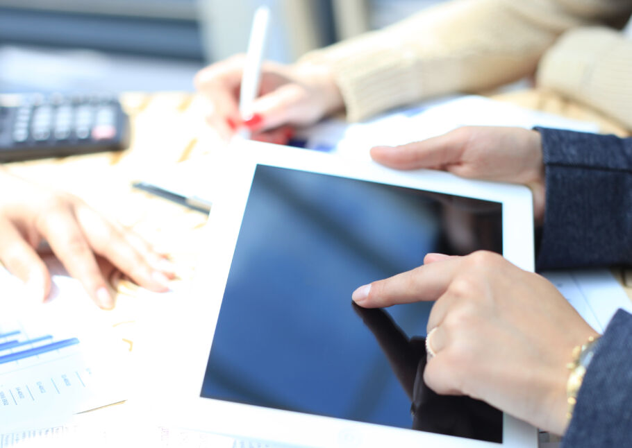 Two people working together with an iPad