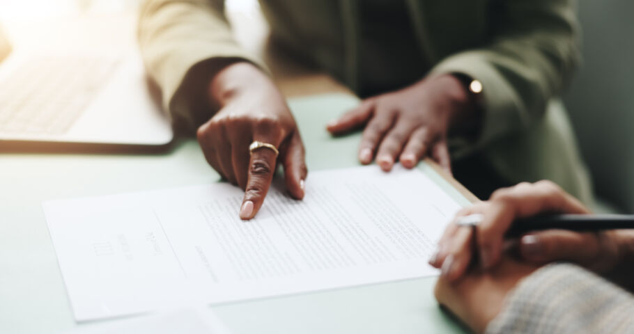 Two people looking at paperwork pointing at document