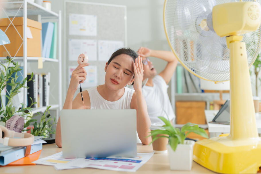 Workers in high temperature hot office with fans