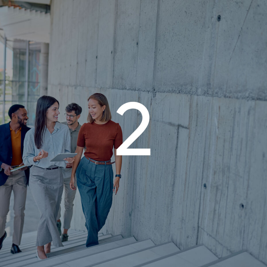 Businesspeople walking up stairs in modern office building graphic overlay