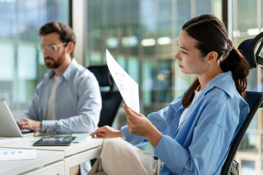 Professionals reading stock paperwork
