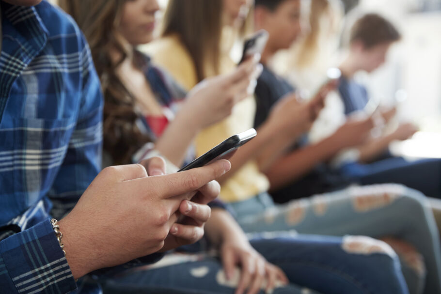 Teenagers online on their phones