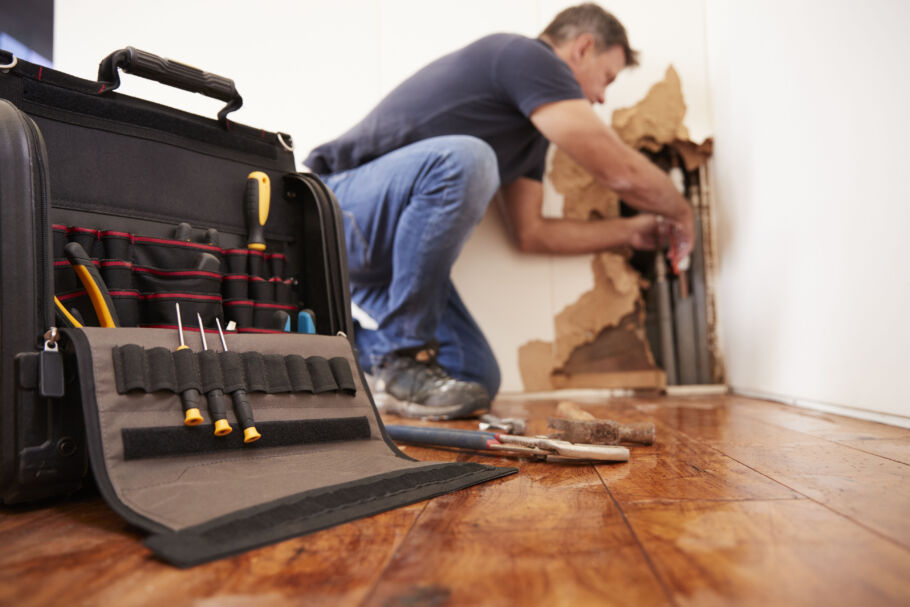 Tradesman repairing broken burst pipes