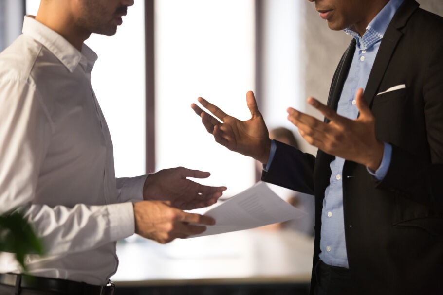 Two employees discussing a document