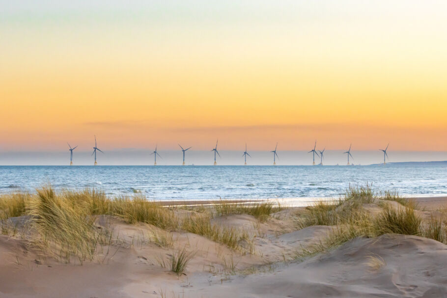 beach with windfarm in the background
