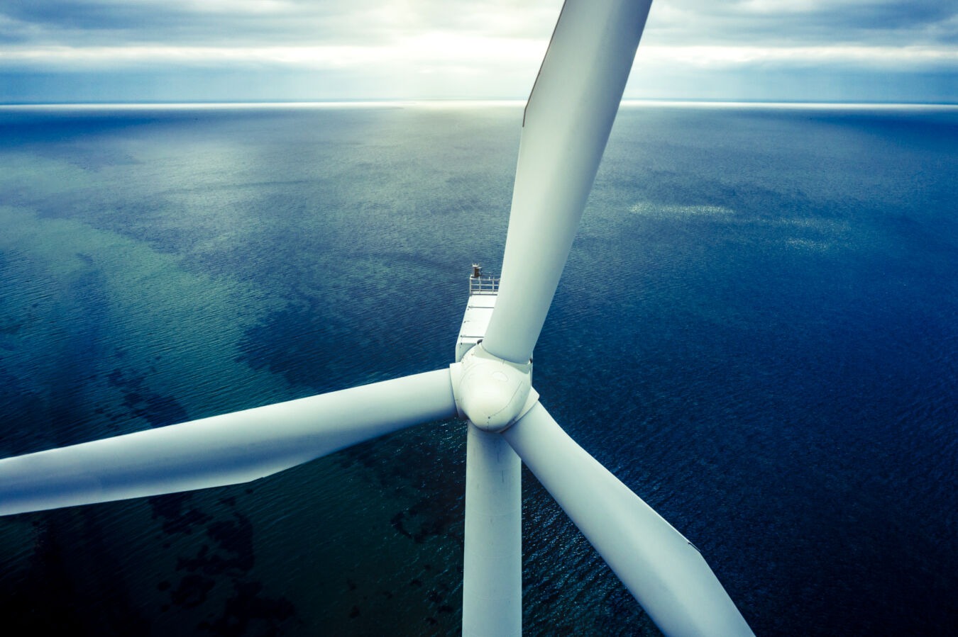 Aerial drone shot of of coastal wind turbines at a wind farm