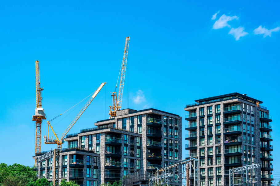 Cranes constructing apartment buildings