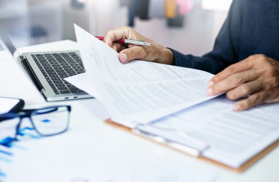 Employee reading over documents while sitting at desk