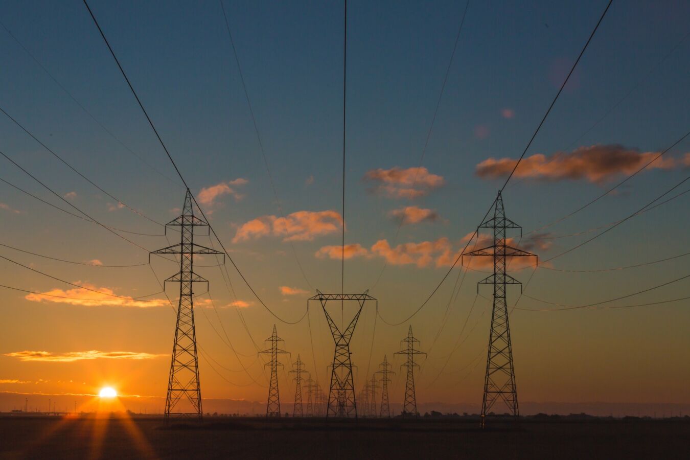 Electricity pylons in the countryside at sunset